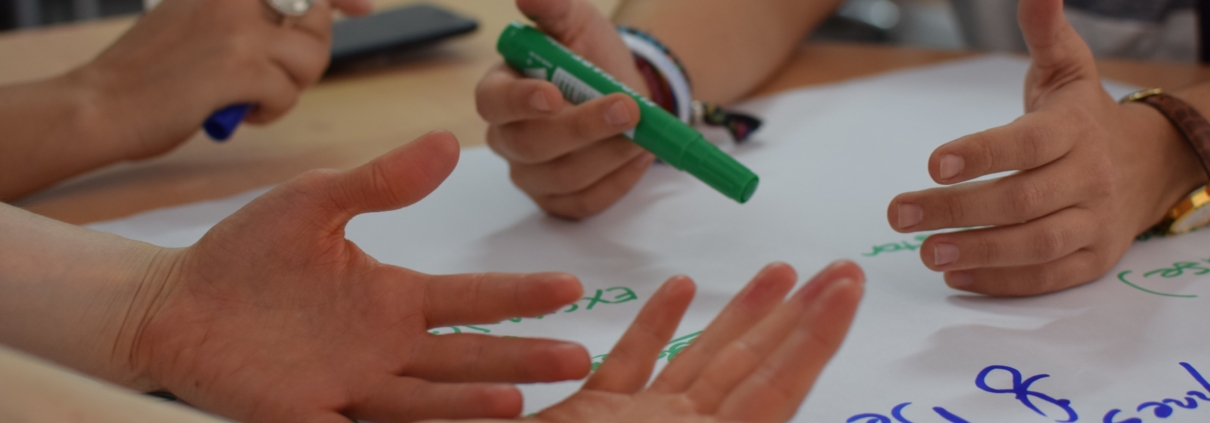 hands writing new ideas on white paper